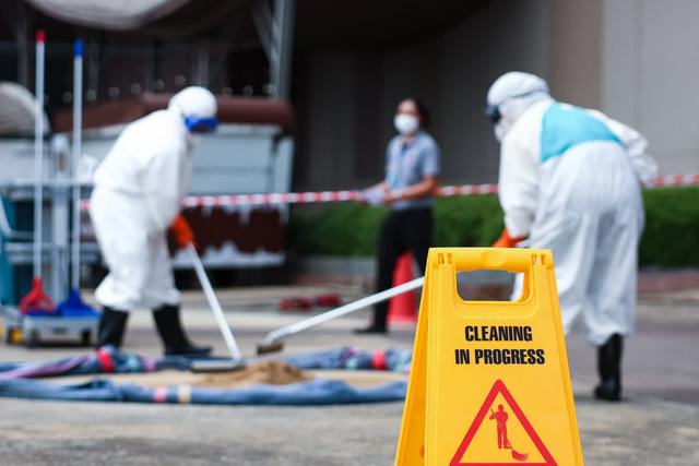 Industrial hygienist conducting a respirator seal check on an employee